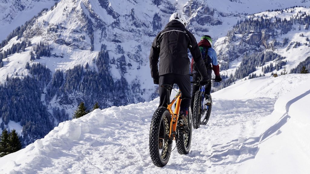 Man Riding  a Bike in snow